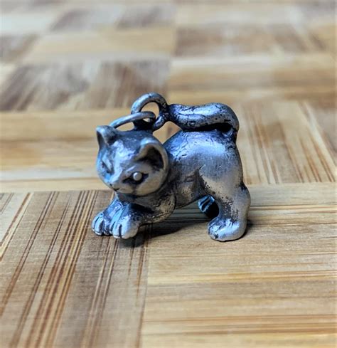 Cat Charm. $48.00. Metal : Sterling Silver. Sterling Silver. Pick a Holder. Shipping. Usually Ships within 1-3 Business Days. In stock, ready to ship. Pick Up.